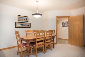 a dining room with a wooden table and chairs at 4312 - Two Bedroom Deluxe Creekside Condominiums condo in Solitude