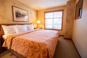 a hotel room with a bed and a window at 3309A - One Bedroom Standard Powderhorn Lodge condo in Solitude