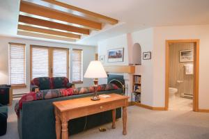 a living room with a couch and a table at 4312 - Two Bedroom Deluxe Creekside Condominiums condo in Solitude +14 photos
