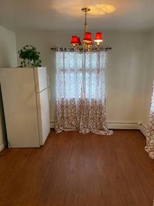 a living room with a refrigerator and a window at Large 3-Bedrooms/2-Bath Apt, One Block to Train in Brooklyn