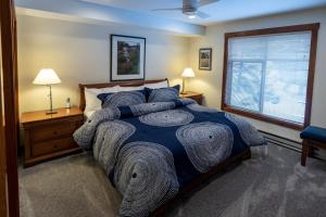 a bedroom with a large bed and a window at 3201 - Two Bedroom Standard Powderhorn Lodge condo in Solitude