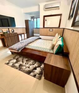 a bedroom with a bed and a mirror at House Of Comfort Delhi in New Delhi