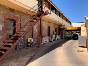 a red staircase on the side of a building at Black Lion Inn Hotel in Broken Hill +10 photos