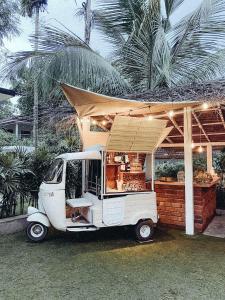 a food cart with awning and a food truckastery at Clics Coliving & Coworking in Hiriketiya