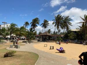 a park with a playground with palm trees and people at Channa Villa & Tours in Bentota