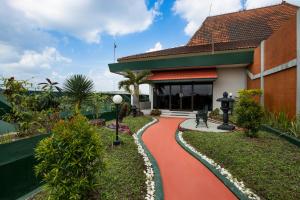 a house with a red walkway in front of it at Sahid Raya Hotel & Convention Yogyakarta in Yogyakarta