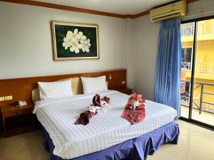Postel nebo postele na pokoji v ubytování Lamai Guesthouse