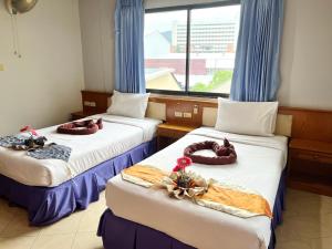 Postel nebo postele na pokoji v ubytování Lamai Guesthouse