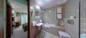 a bathroom with two sinks and a mirror at Monte Casa SPA & Wellness in Petrovac na Moru