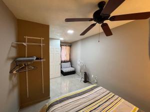 a bedroom with a bed and a ceiling fan at Aparment Rosarito Beach Downtown (C) in Rosarito