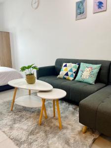 a living room with a couch and a table at Meritus Residensi, Prai Penang in Perai