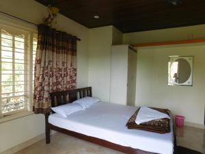 Postel nebo postele na pokoji v ubytování Cauvery Homestay