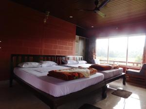 Postel nebo postele na pokoji v ubytování Cauvery Homestay