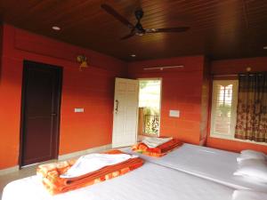 Postel nebo postele na pokoji v ubytování Cauvery Homestay