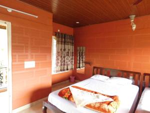 Postel nebo postele na pokoji v ubytování Cauvery Homestay
