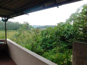 Balkón nebo terasa v ubytování Cauvery Homestay