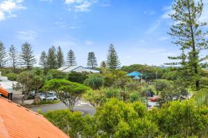 a view of a parking lot with trees and cars at Peregian Beach Apartment in Peregian Beach