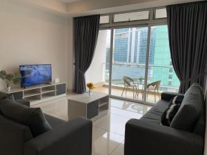 a living room with two couches and a television at KSL Desplanade By Antlerzone in Johor Bahru