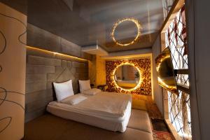 una piccola camera con letto e specchio di Inn OZZ a Karagandy