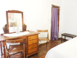 a bedroom with a vanity and a mirror and a dresser at Cortijo Catifalarga Alpujarra in Capileira