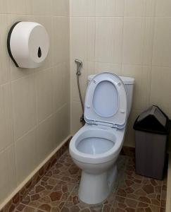 a bathroom with a toilet with a roll of toilet paper at My Capsule Canggu in Canggu