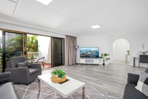 a living room with a couch and a table at Coco Bella Retreat in Central Surfers - sleeps 6-8 in Gold Coast