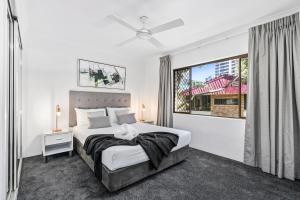 a bedroom with a large bed and a window at Coco Bella Retreat in Central Surfers - sleeps 6-8 in Gold Coast +14 photos