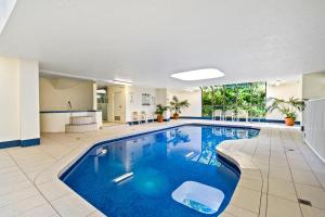 una piscina en una habitación de hotel con agua azul en Coco Bella Retreat in Central Surfers - sleeps 6-8, en Gold Coast