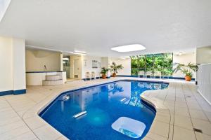 a pool in a hotel room with blue water at Coco Bella Retreat in Central Surfers - sleeps 6-8 in Gold Coast