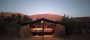 a tent with a table in the middle of a desert at Maggaman Guest House in Tafraoute Sidi Ali