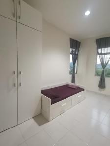 a white room with a bed and a window at Yuslina Homestay in Bandar Puncak Alam