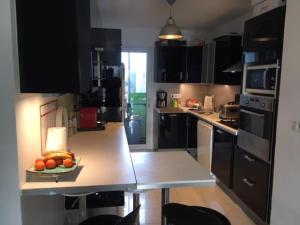 a kitchen with a plate of fruit on a counter at Appartement à 20 mètres de la plage avec balcon in Marseille