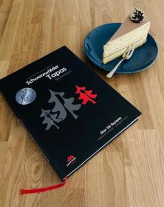 a book sitting on a table with a plate of food at Feldberg Apartment - direkt an der Skipiste - mit Sauna in Feldberg