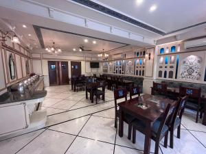 a restaurant with tables and chairs in a room at Ratnawali – A Vegetarian Heritage Hotel in Jaipur