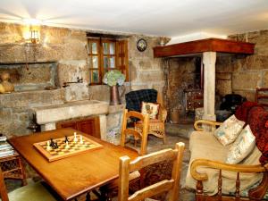 a living room with a chessboard on a wooden table at Pazo de Turbisquedo in Turbisquedo