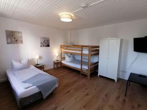 a bedroom with two beds and a bunk bed at Haus Morgentau mit Garten in zentraler Lage in Kassel