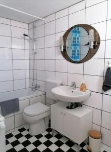 a bathroom with a toilet and a sink and a mirror at Haus Morgentau mit Garten in zentraler Lage in Kassel