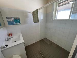 a bathroom with a shower and a sink at Black Lion Inn Hotel in Broken Hill