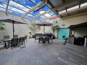a patio with a table and chairs and an umbrella at Black Lion Inn Hotel in Broken Hill