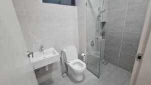 a bathroom with a shower and a toilet and a sink at Luxury 5STAR 2Room Resort Suite Mid Valley Sunway Kuala Lumpur by Stayz Suites in Kuala Lumpur