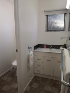 a bathroom with a sink and a toilet at Paku Lodge Resort in Tairua +48 photos