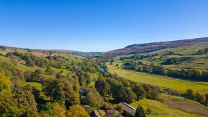an aerial view of a valley in the hills at Peep-O-Day-Stylish 4bedroom cottage with Dale view in Feetham