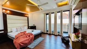 a bedroom with a bed and a ceiling fan at Olive Service Apartments - Green Park in New Delhi
