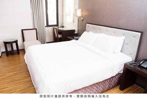 Postel nebo postele na pokoji v ubytování Royal Group Hotel Chun Shan Branch