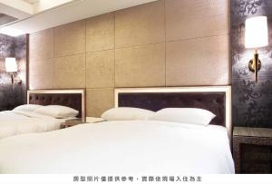 Postel nebo postele na pokoji v ubytování Royal Group Hotel Chun Shan Branch