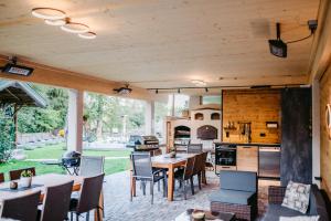 an outdoor patio with tables and chairs and a kitchen at Appartement Viehhauser in Kleinarl