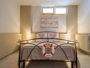 a bedroom with a bed with a surfboard on it at Notte Della Taranta Luxury Holiday in Carpignano Salentino