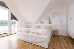 Apartment Seeblick _P7 A7 _ في بلاو ام سي: غرفة نوم بيضاء مع سرير أبيض ونافذة كبيرة