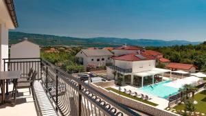 arial view of a villa with a pool and a resort at Cool Šilo Appartement Resort in Šilo