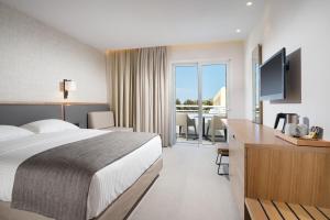 Postel nebo postele na pokoji v ubytování Platanista Hotel